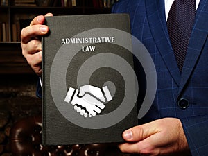 Attorney holds ADMINISTRATIVE LAW book. Administrative lawÂ is the body of law that governs the activities of administrative